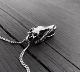 Skull necklace on rustic wooden table, intricate design | Moon Raven