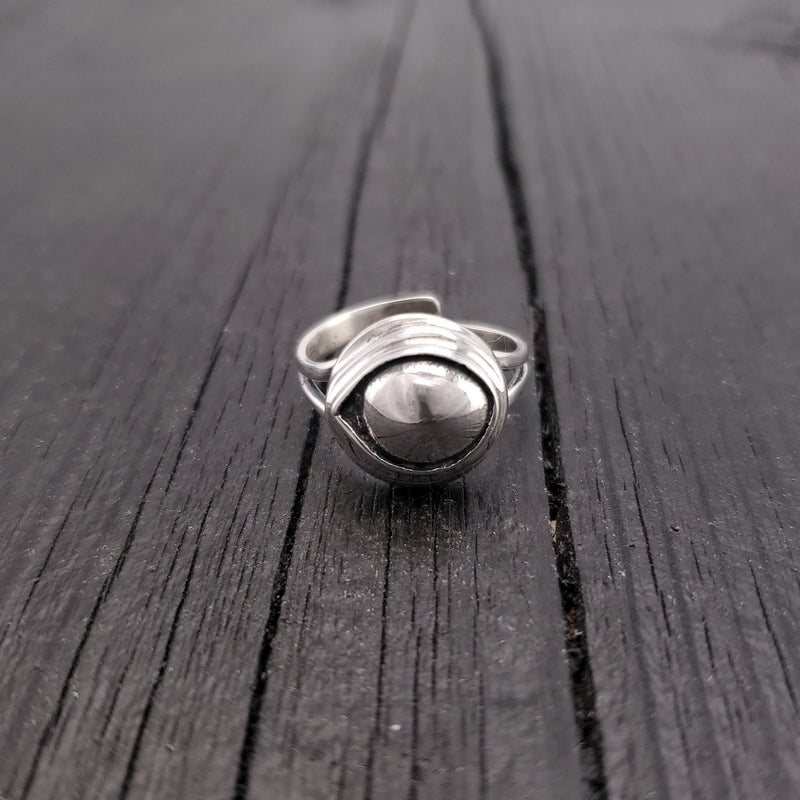 Cast it in solid sterling silver that has been hand oxidized it to a stunning finish. As you can see by the reflection in the convex surface, the eye sees all and is guaranteed to repel all evil directed towards its wearer.