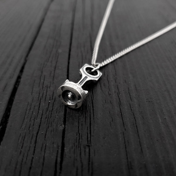 This piston and rod pendant measures 1” Long by 3/8&quot; wide. The precisely detailed 3D rod and piston are cast in one solid piece of sterling silver.