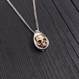 My cremation urn pendant is made of stainless steel with a mirror finish. Mounted on the front is a detailed bronze human skull. A discreetly placed screw can be removed from the bottom revealing a small chamber for a small amount of cremated ashes