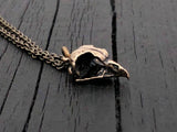 This little Great Horned owl skull, a mere 11/16&quot; long is cast in solid bronze. It is a perfectly proportional 3D miniature of a real great horned owl skull and retains all the unique details of the life size skull.